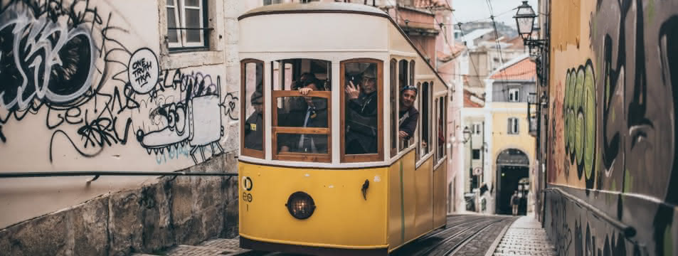 a typical lisbon tram going up the street